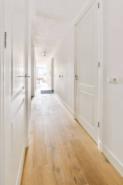istock Narrow corridor with doors and lamp 1457190389