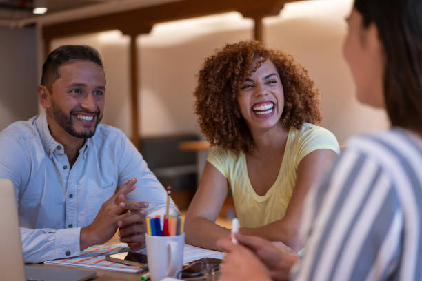 istock Diverse colleagues laughing during a meeting at a coworking office 1457193233