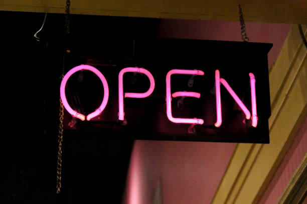 istock Open sign in pink neon hanging in a business window 1457193375