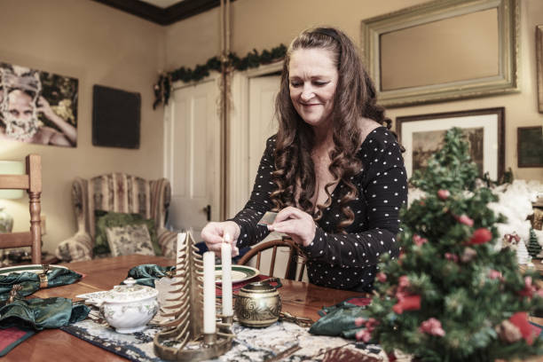 istock Mature woman setting up the table for Christmas dinner 1457195078