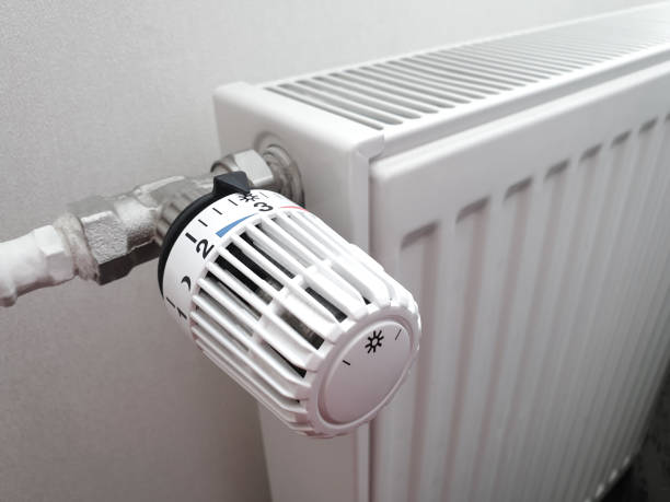 istock Battery temperature controller. Heating radiator. Thermostat closeup. Middle position. 1457195641
