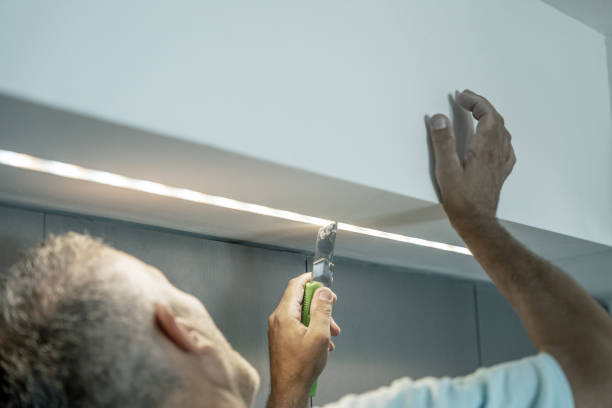 istock Installing led strip for lighting correctly on the surface of the Cabinet on the kitchen set 1457195774
