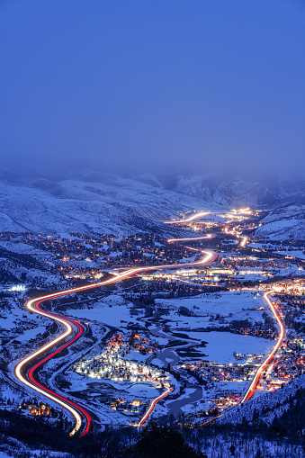 Eagle and Vail Valley Winter Dusk View - Scenic view of lights showing Vail, Avon, Beaver Creek, Edwards, and Wolcott Colorado at dusk during blue hour. Long exposure with light trails twilight landscape.