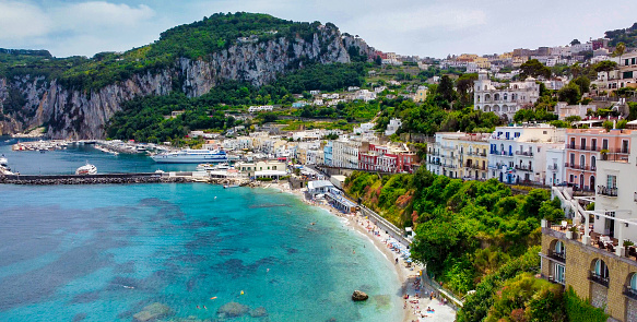 Beautiful coastline of Capri along the port area. Aerial view from drone