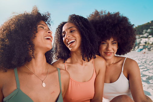 Happy, friends or black woman with smile at the beach for freedom, vacation or holiday in Miami in summer. Travel, blue sky or group of girls bonding, laughing or comic picnic on sand portrait.