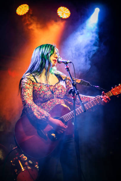 istock Acoustic Female Singer Under Stage Lights 1457199104