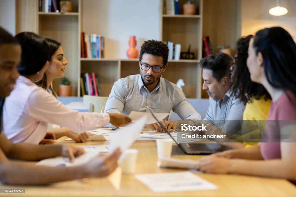 Team of business people brainstorming in a meeting at the office Team of Latin American business people brainstorming in a meeting at the office - teamwork concepts Chaos Stock Photo