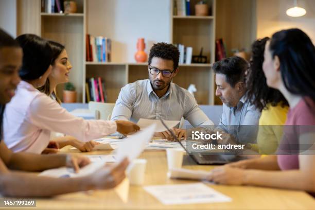 Team Of Business People Brainstorming In A Meeting At The Office Stock Photo - Download Image Now