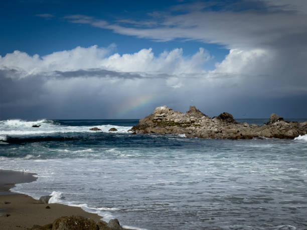 istock Dramatic coastline with rock formation in the water, dramatic storm clouds and a rainbow 1457200032