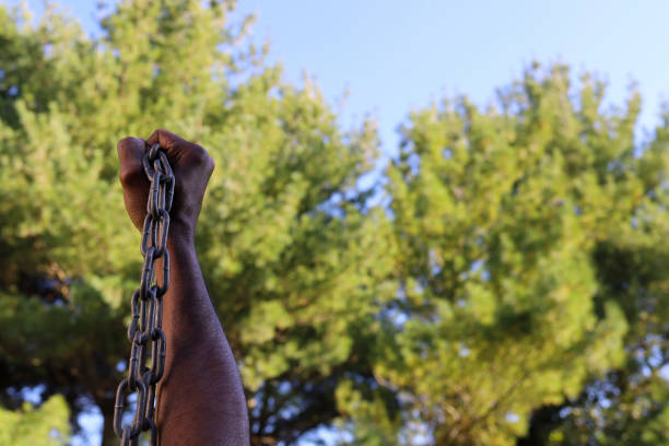 A black African-American man holding a chain in his hand