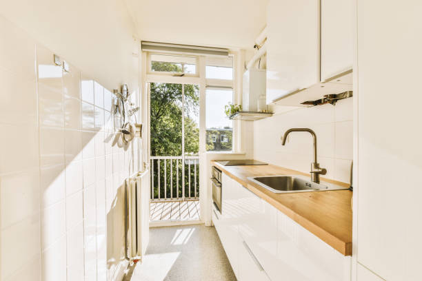 Interior of modern kitchen with white furniture
