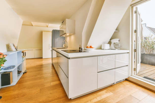 istock Mansard room of apartment with open kitchen and sofa 1457202724