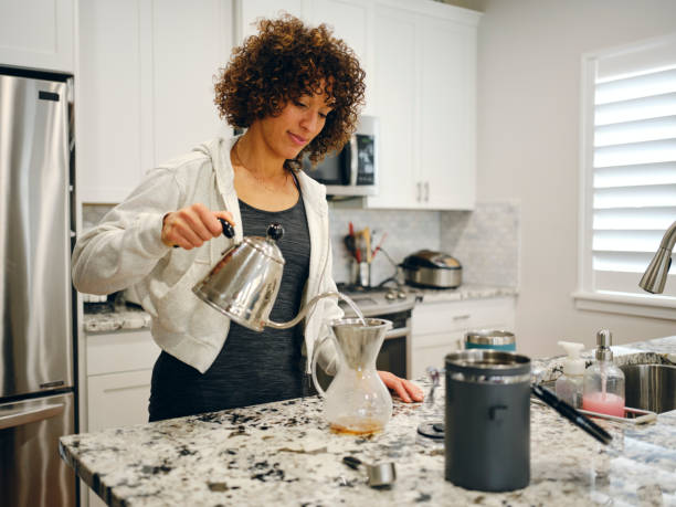 istock Woman Making Coffee in a Home Kitchen 1457204117