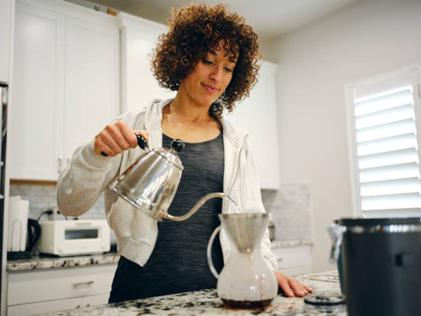 istock Woman Making Coffee in a Home Kitchen 1457204178