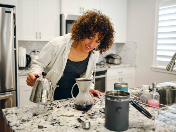 istock Woman Making Coffee in a Home Kitchen 1457204231
