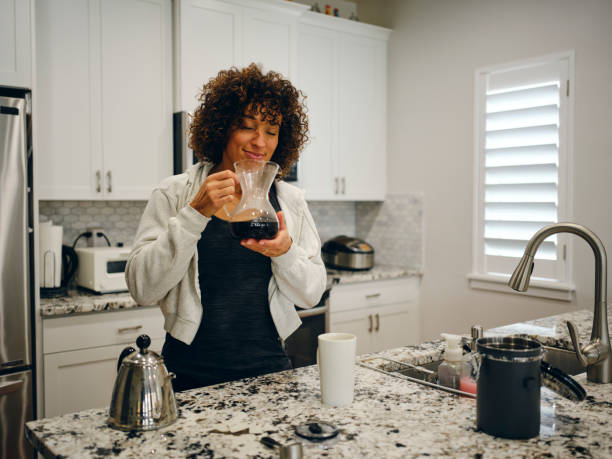 istock Woman Making Coffee in a Home Kitchen 1457204491