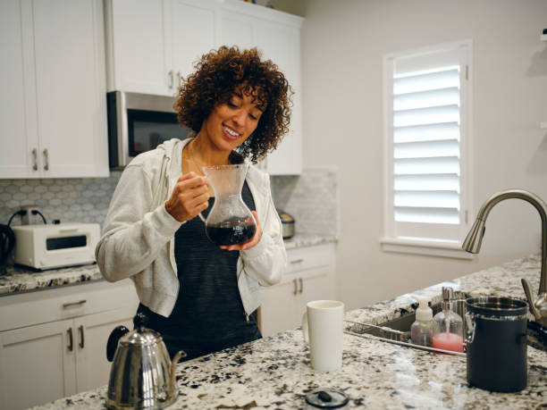 istock Woman Making Coffee in a Home Kitchen 1457204528