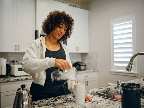 istock Woman Making Coffee in a Home Kitchen 1457204574
