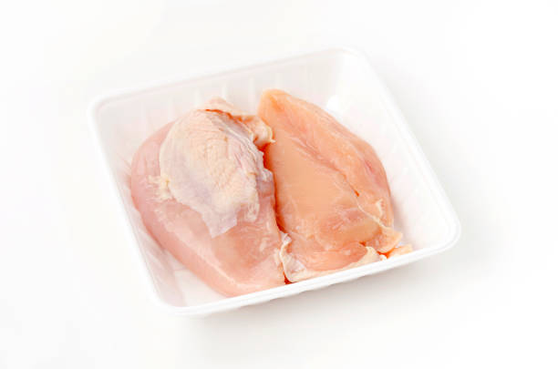 istock Raw Chicken breast on a foam tray on a white background 1457205264