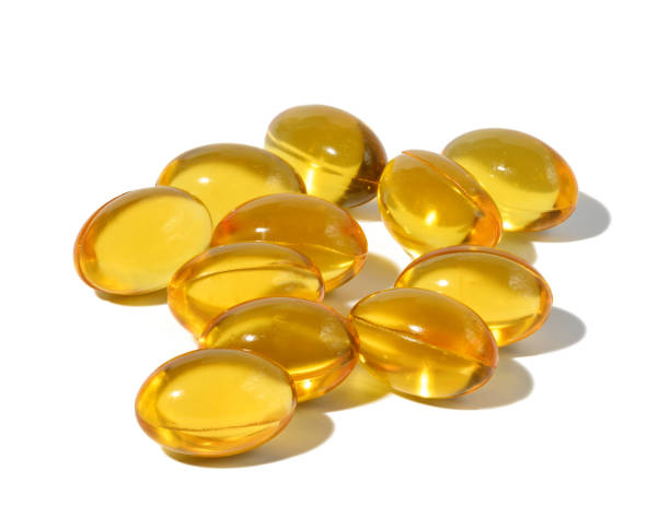istock Yellow capsules with fish oil on a white background 1457206052