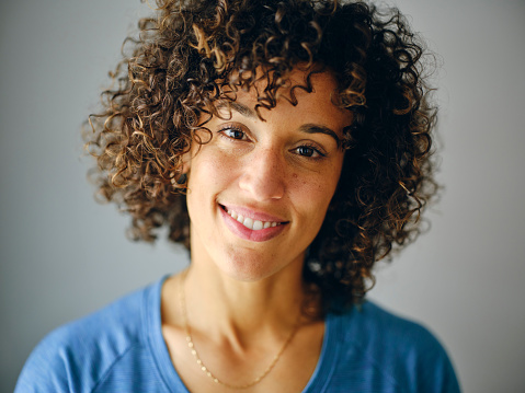 A close up natural light portrait of a multiracial woman.