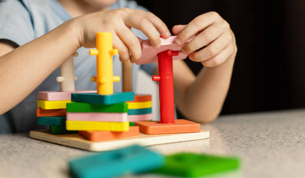 istock Close-up of children's hands playing with an educational multi-colored puzzle toy 1457209088