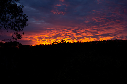 Orange, pink, red and blue sunrise over Perth Hills in Western Australia