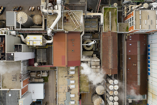 Industrial plant, paper mill, with smoking chimneys viewed directly from above.