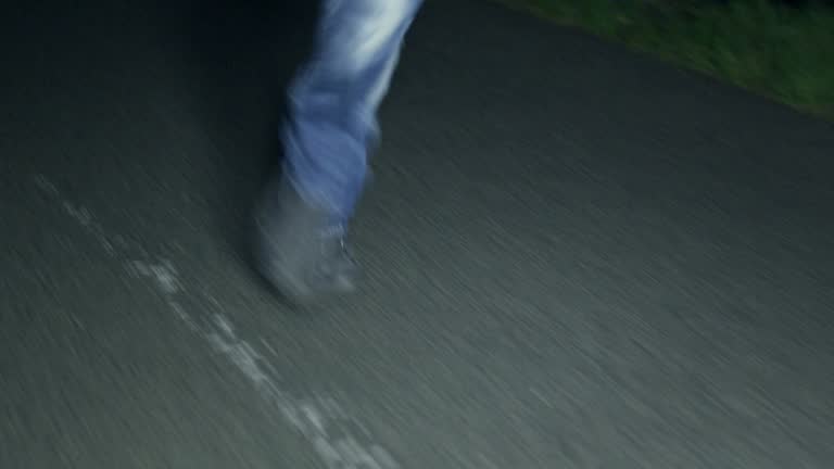Feet running on dark street
