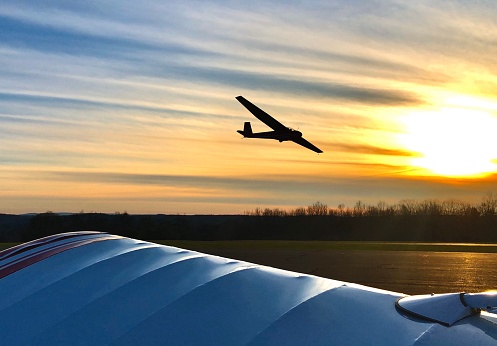 Sunset Over Wing - 11/14/20: A color photograph of a glider landing at sunset, in \nNew York State.