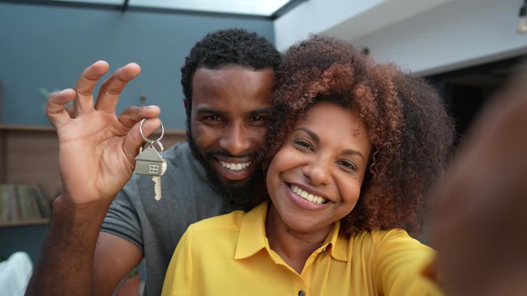 Ecstatic couple making selfie in new house