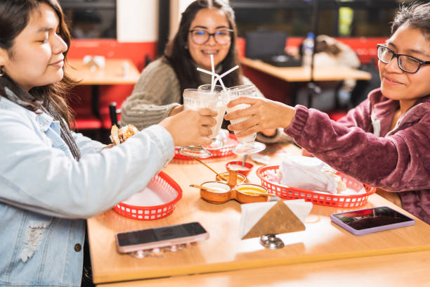 istock Friends toasting with milkshakes in a restaurant 1457216917