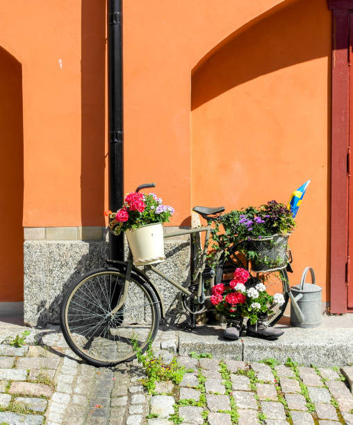 istock a bicycle decorated with flowers by the house wall 1457217608