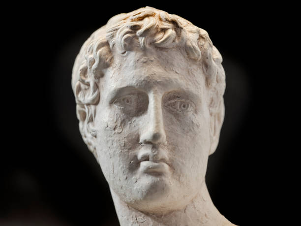 An ancient statue of a young man from ancient Greece presumed to be a  philosopher or poet, severe and sad. Small reproduction of original