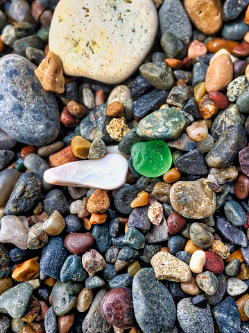 Glass and stones on a beach, California