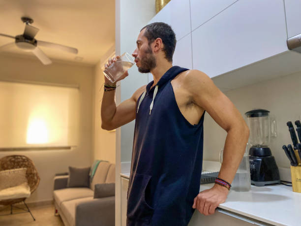 istock Man Drinking Water After Home Workout 1457223124