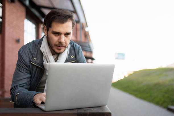istock male IT worker working on laptop outside 1457227683