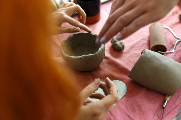 istock Pottery workshop class. A pottery crafts dish from a raw clay. Creating ceramics 1457227826