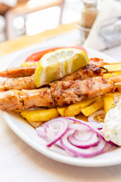 Traditional Greek food served in tavern, made from Kebab Beef Souvlaki, french fries, salad and pita bread