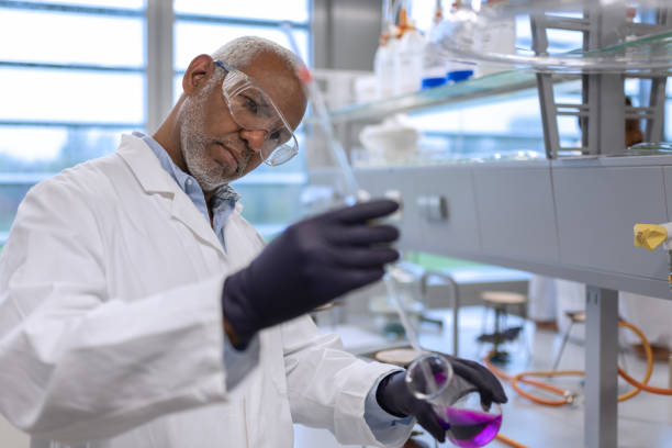 Student researchers while working in a chemistry lab while working with chemicals.