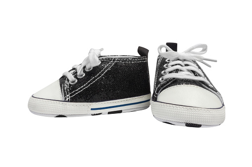 Black and white baby sneakers, front and side view, isolated.