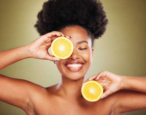 Skincare, wellness and black woman with lemon in studio for organic, natural and healthy skincare products. Beauty, cosmetics and girl with fruit advertising vitamin c, minerals and fresh spa facial Skincare, wellness and black woman with lemon in studio for organic, natural and healthy skincare products. Beauty, cosmetics and girl with fruit advertising vitamin c, minerals and fresh spa facial vitamin c stock pictures, royalty-free photos & images