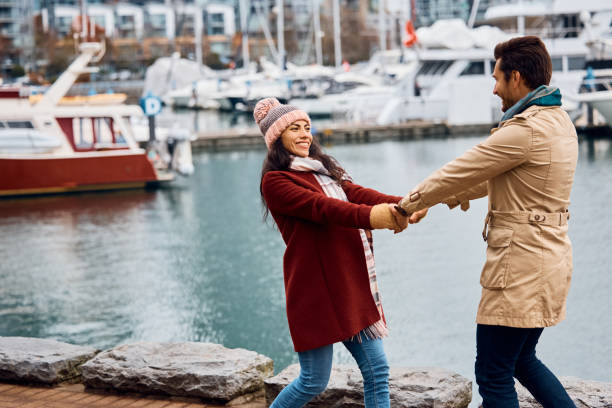 istock Carefree couple having fun while spinning on city quay. 1457239886