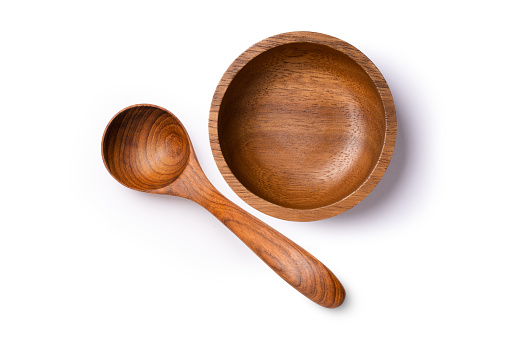 Wooden bowl and spoon isolated on white background.