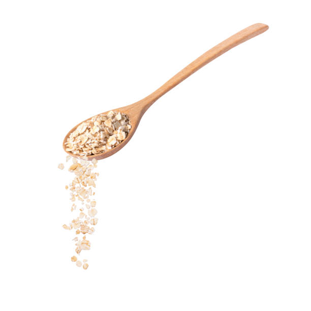 istock Oat flakes pouring from wooden spoon 1457243204