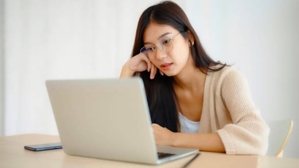 istock Young asian woman upset, frustrated by problem with work or relationships,  feeling despair and anxiety, loneliness, having psychological trouble 1457243531