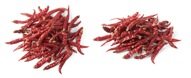 pile of dried red chili or cayenne peppers in different angles, set of hot spice isolated on white background, collection
