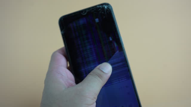 Man holding and touch a smartphone with broken screen and smart phone system failure