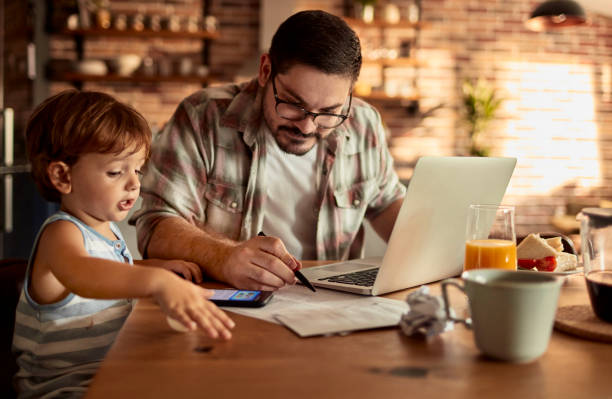 istock Father going over the home finances while his son is using a phone 1457249839
