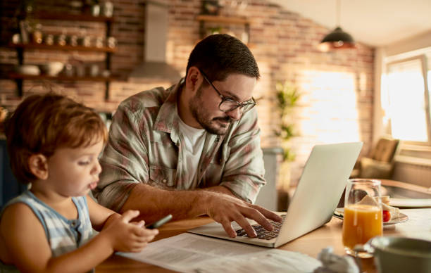 istock Father going over the home finances while his son is using a phone 1457249965